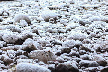 Frozen river in winter with snow and ice on the rocks, Georgia