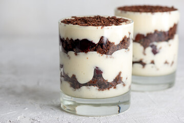 Brownie cake trifle, Black forest dessert with chocolate biscuit and whipped cream in a glasses. Vegan dessert.