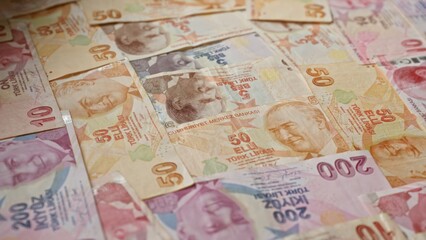 Turkish banknotes scattered showcasing various denominations of lira currency from turkey, highlighting financial themes related to money, banking, and economy.
