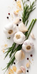 A bunch of garlic and parsley are on a white background. The garlic is cut in half and the parsley is green