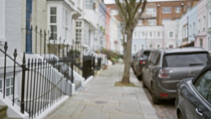 Blurred street scene in chelsea, london during winter with parked cars, trees, and distinctive uk architecture, highlighting an out of focus urban residential area.