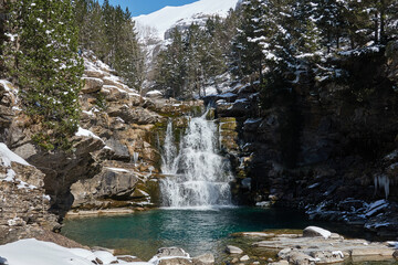 The Soaso Steps, a breathtaking series of waterfalls in the Ordesa Valley, Ordesa and Monte Perdido National Park, completely covered in snow during winter. A magical frozen landscape in the Spanish P