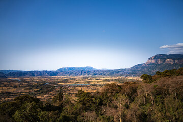 Naklejka premium A panoramic view of the landscape in Laos, showcasing the vast valleys, mountains, and forests.