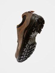 Brown Safety working boot with non-slip soles in perspective, isolated on white background. For men...