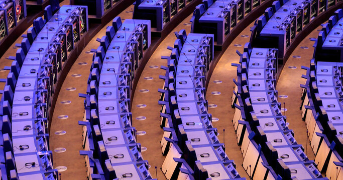 Strasbourg, France - Jun 8, 2024: Rows of European Parliament seats in Strasbourg with open communication panels, showing exposed wiring and headsets during a transition after EU elections.