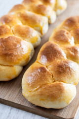 Traditional Easter braided bread. Tsoureki braid on white wooden table
