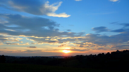 Beautiful sunset sky in a rural village Gliczarow Gorny, Poland, Europe. Clouds on blue orange sky. Tatra mountains in the background