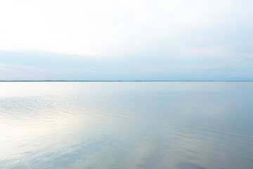 Quiet calm water of Boschettona Lagoon, Venice Lagoon. Pastel blue shades of the lagoon merge with...