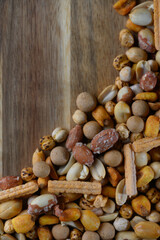 Colorful assortment of nuts and snacks arranged artfully on a wooden surface, capturing the essence of a delightful treat spread