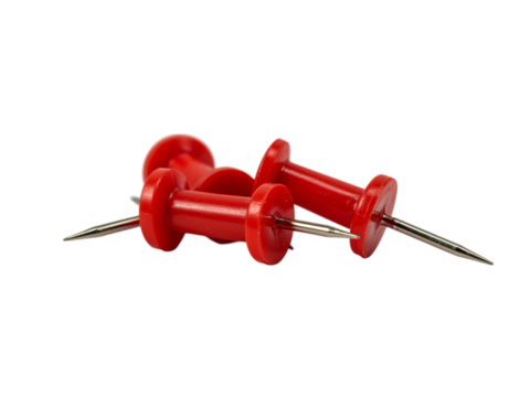 Three bright red pushpins with silver/steel colored points are clustered together