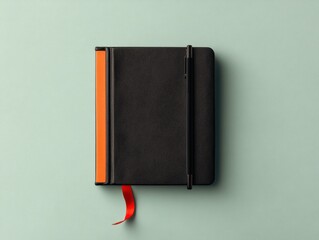 Elegant black notebook on pastel background.
