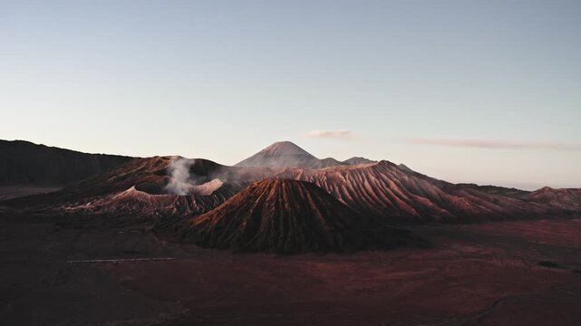 Sunrise Mount bromo and mount batok emitting smoke at dawn