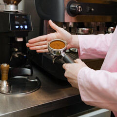 Barista Skillfully Preparing Espresso at a Bustling Coffee Shop in the Morning Light