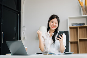 business woman are delighted and happy with the work they do on their tablet, laptop