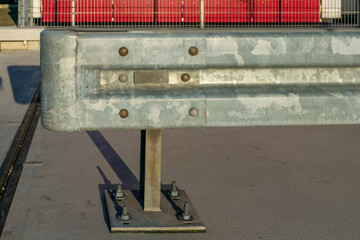 Metal safety barrier installed on a concrete surface in a construction area during daylight