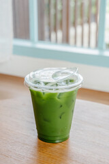 Iced clear matcha in a plastic glass.