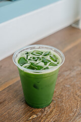 Iced clear matcha in a plastic glass.