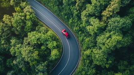 Aerial view ,car driving on asphalt road in mountain green forest.