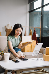 Startup small business SME, Entrepreneur owner woman using smartphone or tablet taking receive and checking online purchase shopping order