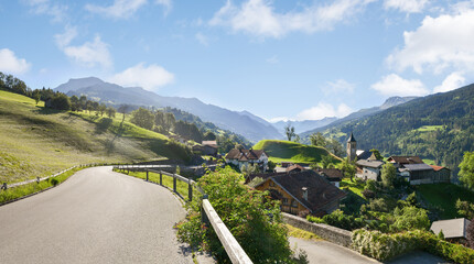 idyllic historic village Luzein, with farmsteads, hill and church. alpine landscape switzerland...