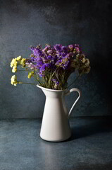 Beautiful Limonium Sinuatum flowers with lovely vintage background in vase.