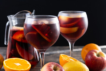 Refreshing Summer Citrus Fruit Sangria in crystal jar on wooden table