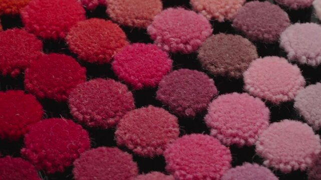 Collection of colorful carpet pile samples on tray moving in isometric view. Close up view. Textile industry concept.