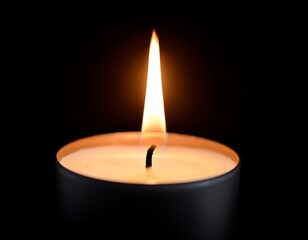 Flickering candlelight creates a serene atmosphere in a darkened room during an evening setting