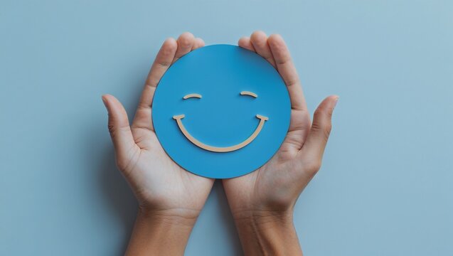Hands Holding Blue Smiley Face - Powered by Adobe