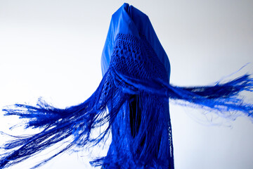 Abstract blue fabric art with dynamic fringes and geometric shapes