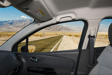 Car window with view of desert road, Death Valley, USA