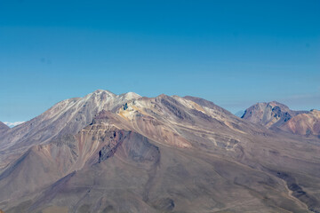 Volcanic desert landscape of Andes mountains in South America. High mountain summit in the middle of desert high altitude altiplano, volcano El Misti crater near Arequipa city in Peru. Volcanic land