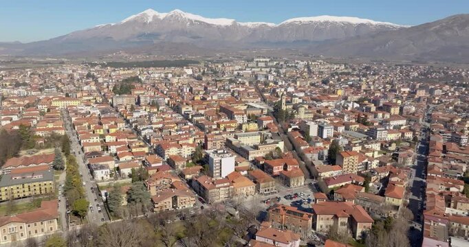 Aerial view of the city of Avezzano, in Abruzzo, Italy. In the background the snow-capped mountains.