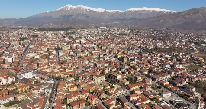 Aerial view of the city of Avezzano, in Abruzzo, Italy. In the background the snow-capped mountains.