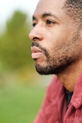 Obraz premium Pensive black man contemplating outdoors in nature