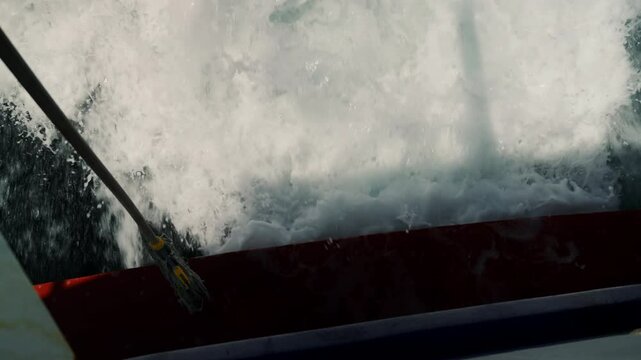 Water turbulent beneath the ship, rear view of water being ejected from the boat engines.