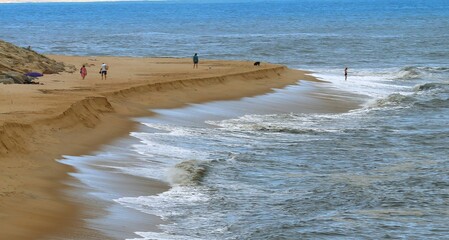 Ocean shore close-up. Wet sand. Sea foam. Waves. Color image. Poster. Wallpaper. Background....