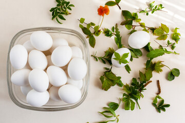 DIY Easter eggs with natural materials using leaves and flowers. Creating patterns on eggs using plants, selective focus.