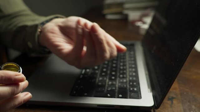 Oral Drug user swallows over dosage of pills in office workspace CLOSE-UP
