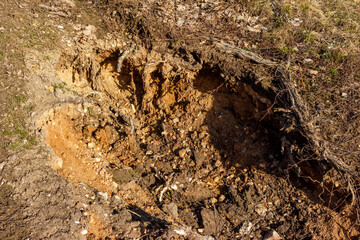 The water has caused the sand to erode, resulting in soil erosion