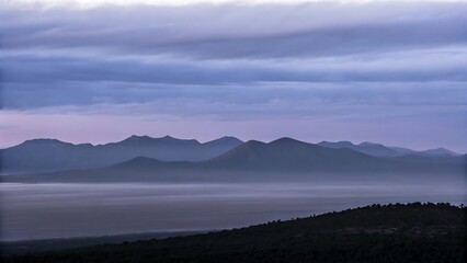Obraz premium Misty Mountain Range at Dawn