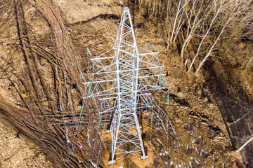 A bird's-eye view of a recently constructed power transmission tower with extended cables