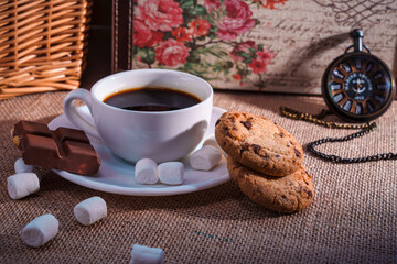 Vintage still life with coffee, chocolate, cookies, and pocket watch