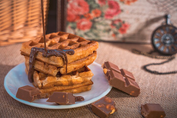 Waffles with dripping chocolate, chocolate pieces, and pocket watch
