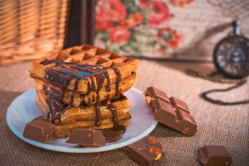Waffles with dripping chocolate, chocolate pieces, and pocket watch