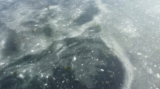 aerial footage of frozen Loch Beanie - a scottish mountain lake in the highlands