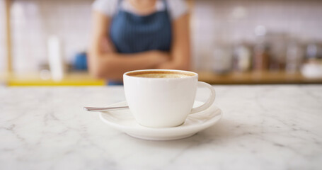 Waitress, coffee and closeup of cup in cafe for espresso, hospitality and breakfast server. Caffeine beverage, latte and barista with drink and person in bakery for small business and restaurant