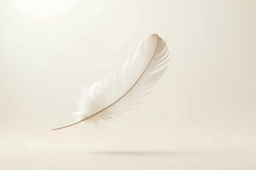 Obraz premium A single white feather floats gently on a soft, beige background, evoking a sense of peace and tranquility with delicate lighting and a minimalist aesthetic.