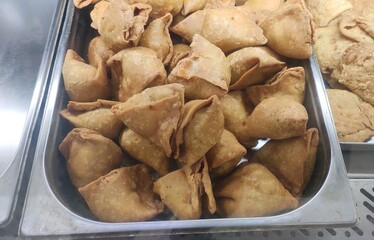 One of the most popular Indian snacks called Samosa in local language. It is a fried or baked pastry with a savoury filling, such as spiced potatoes, onions, peas etc. It is triangular cone shaped.