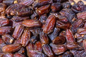Naturally sweet dried dates glistening under warm sunlight at a vibrant market in the Middle East